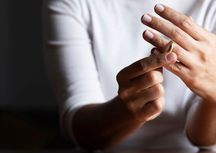 a person taking off a wedding ring