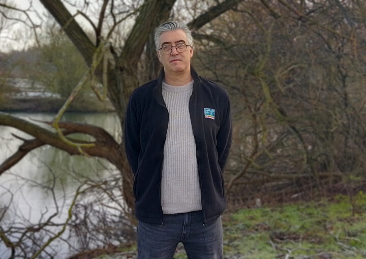 man stands in front of a tree