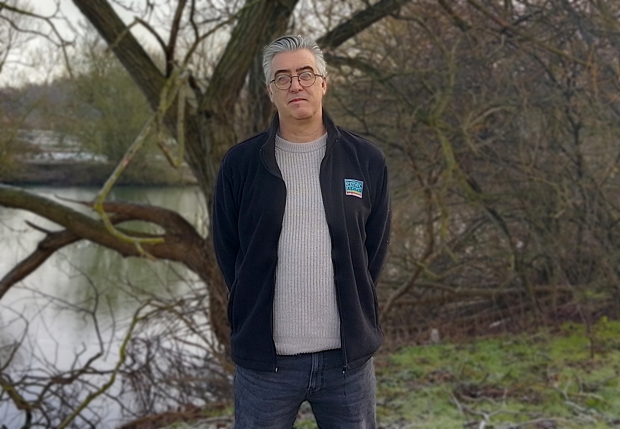 man stands in front of a tree